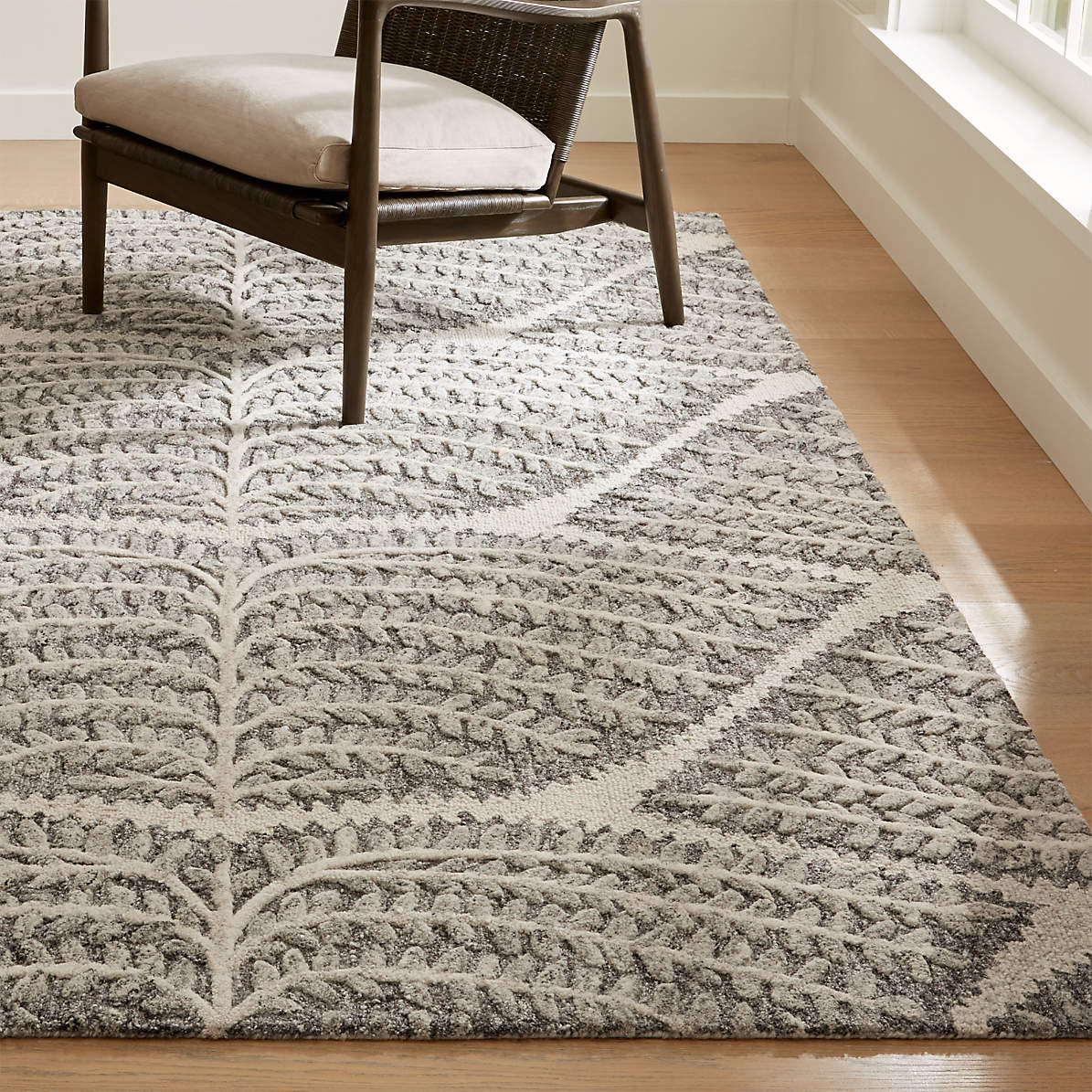 Neutral textured Crate and Barrel style area rug in a modern room
