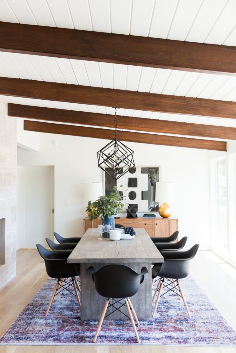 Large area rug defining a dining room with modern farmhouse details