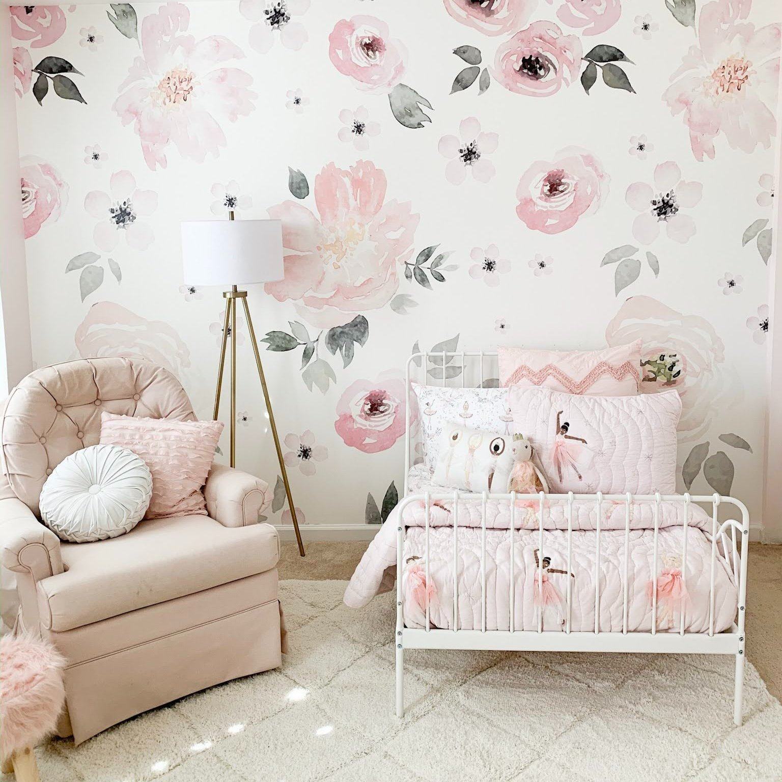 Soft pink floral wallpaper in a stylish toddler bedroom