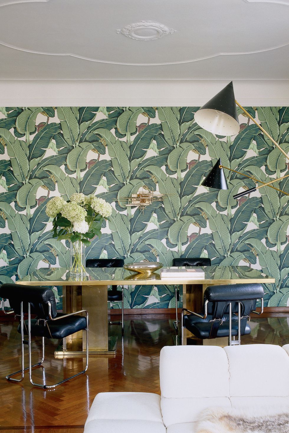 Tropical palm leaf wallpaper with black and white modern furniture